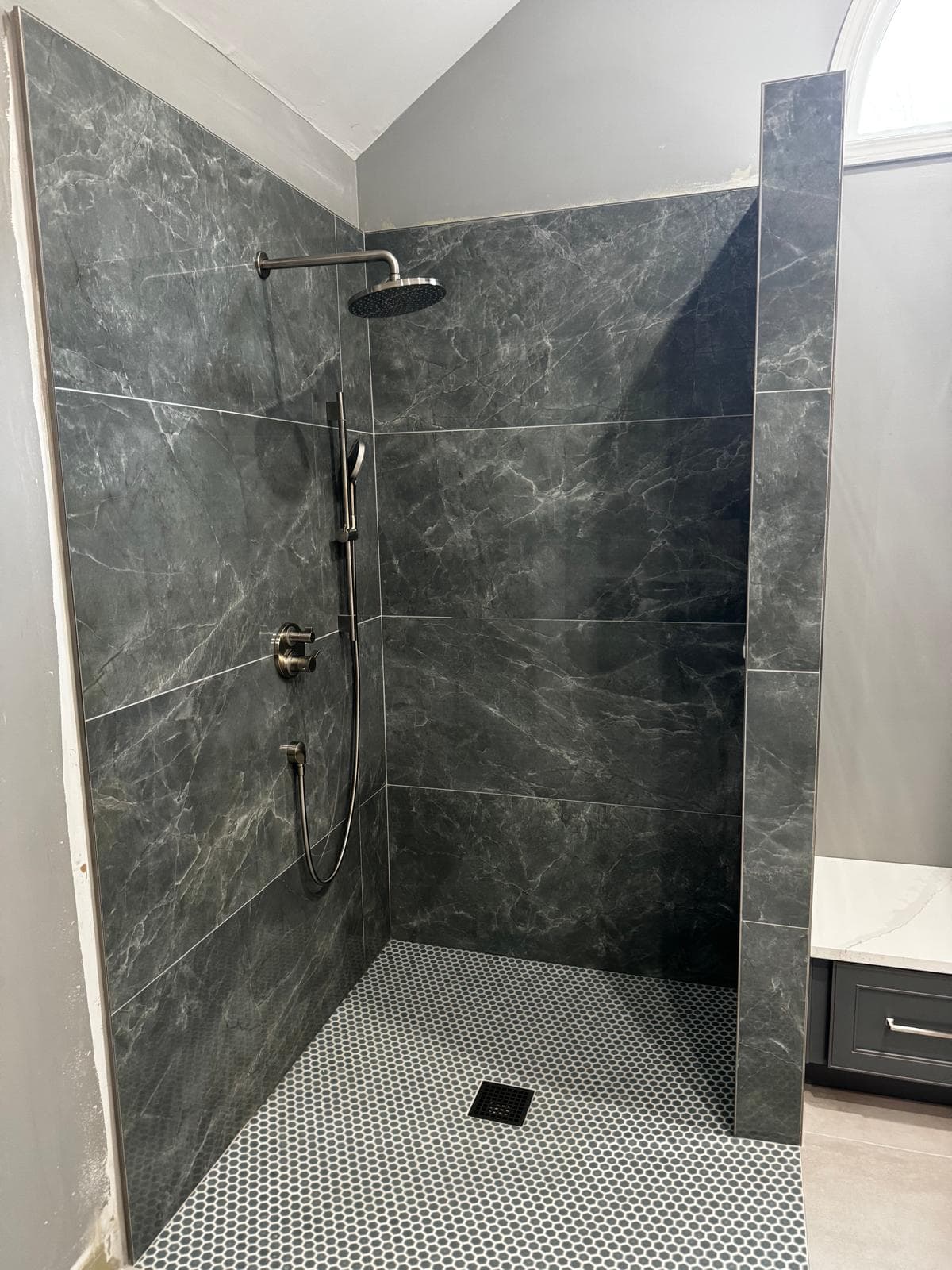 Walk-in shower with charcoal marble-look tile and rainfall shower head, Atlanta, GA