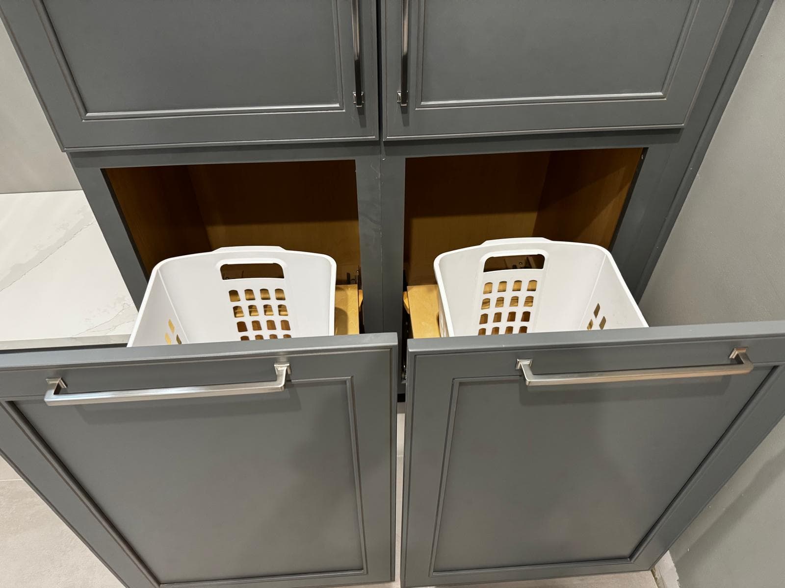 Custom pull-out laundry hamper drawers in bathroom vanity cabinetry, Atlanta, GA