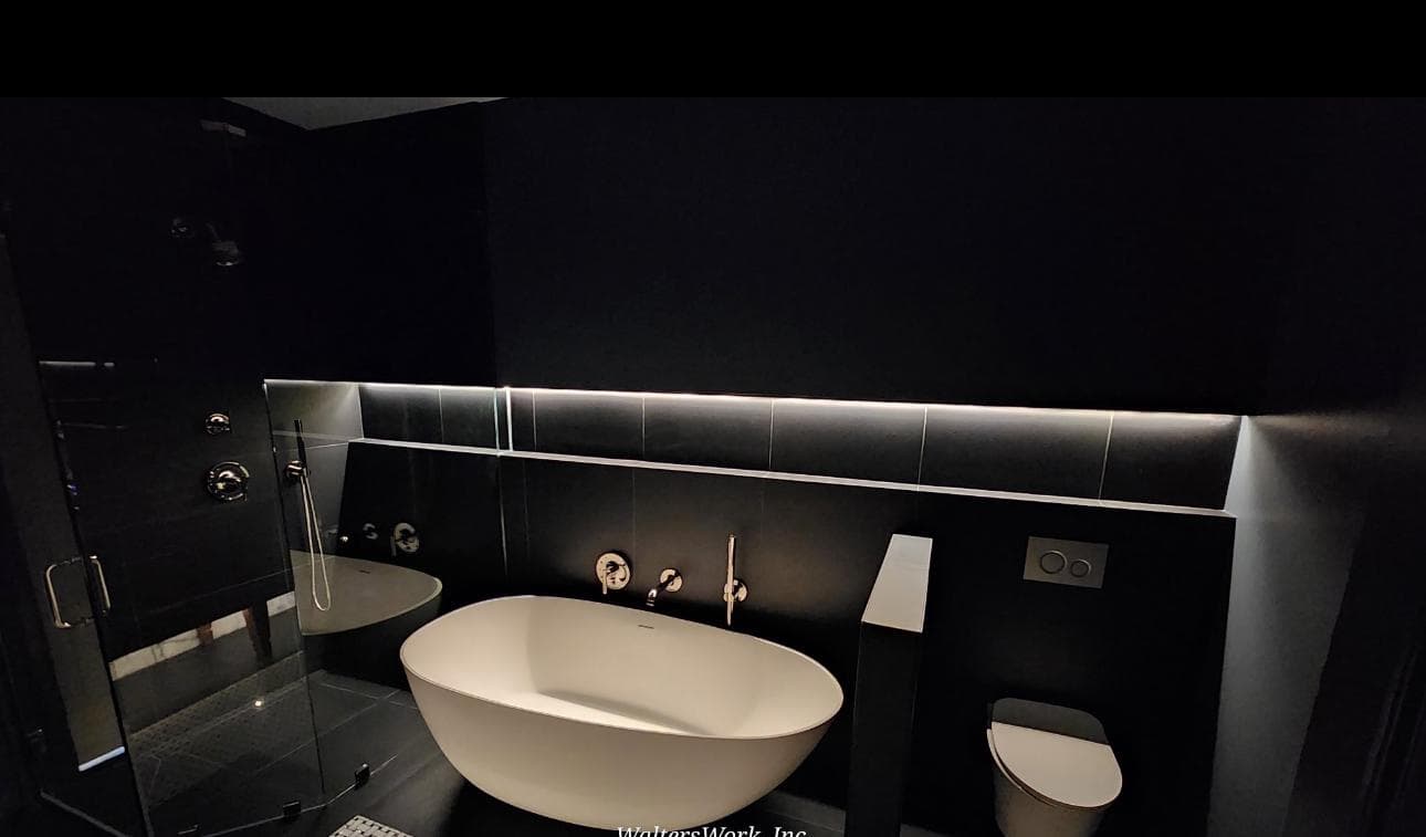 Wall-hung toilet in black tile powder room with backlit ledge, Atlanta, GA