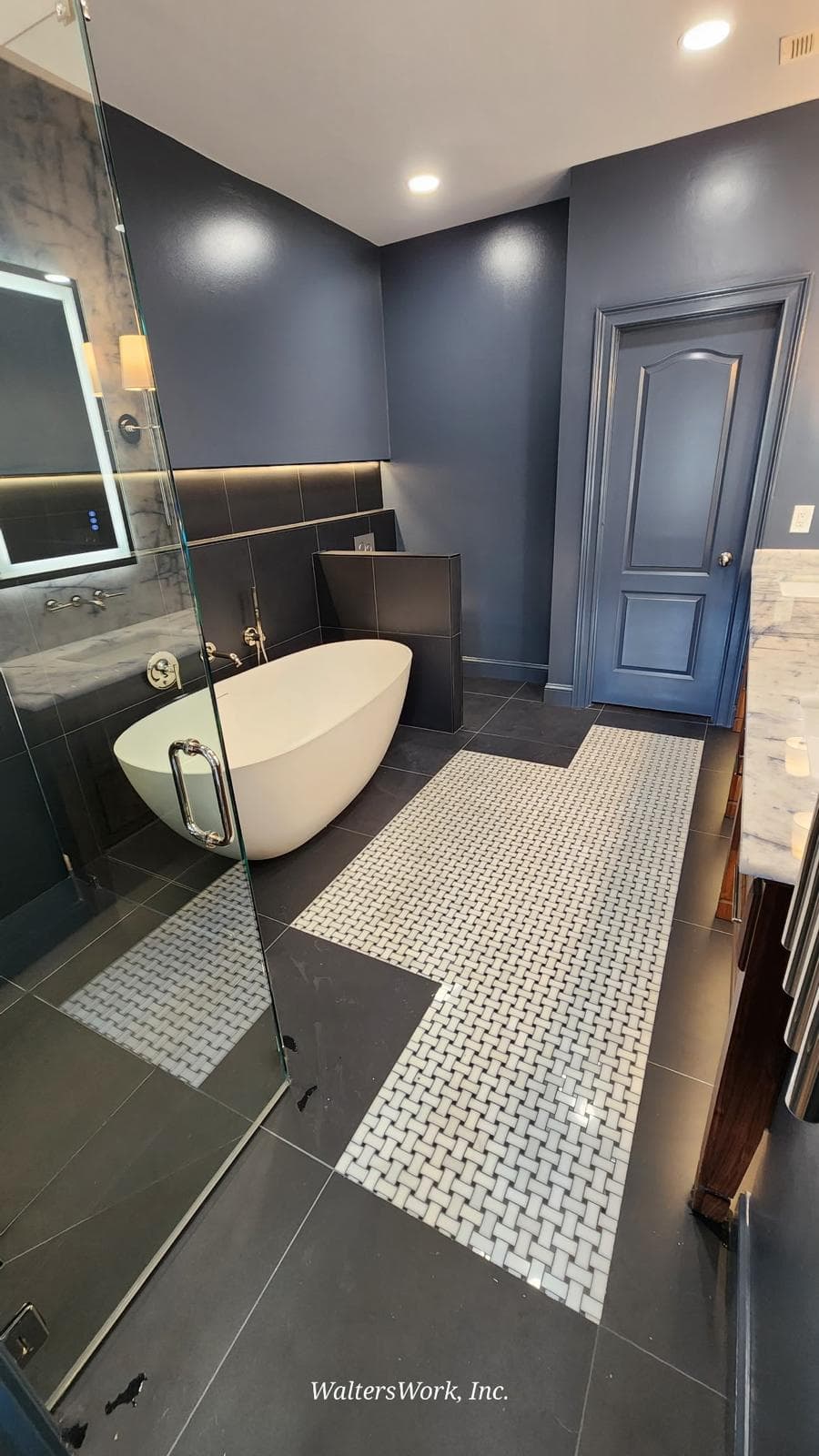 Freestanding soaking tub with black tile surround and backlit niche, Atlanta, GA