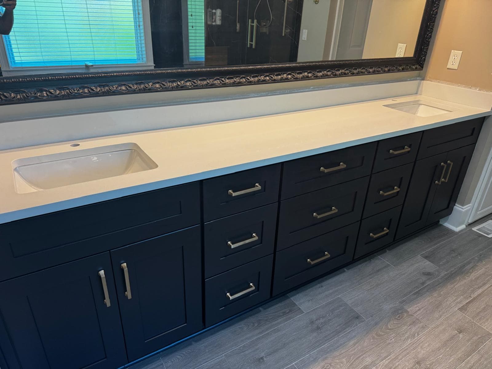 Navy blue double vanity with white quartz countertop and framed mirror, Atlanta, GA