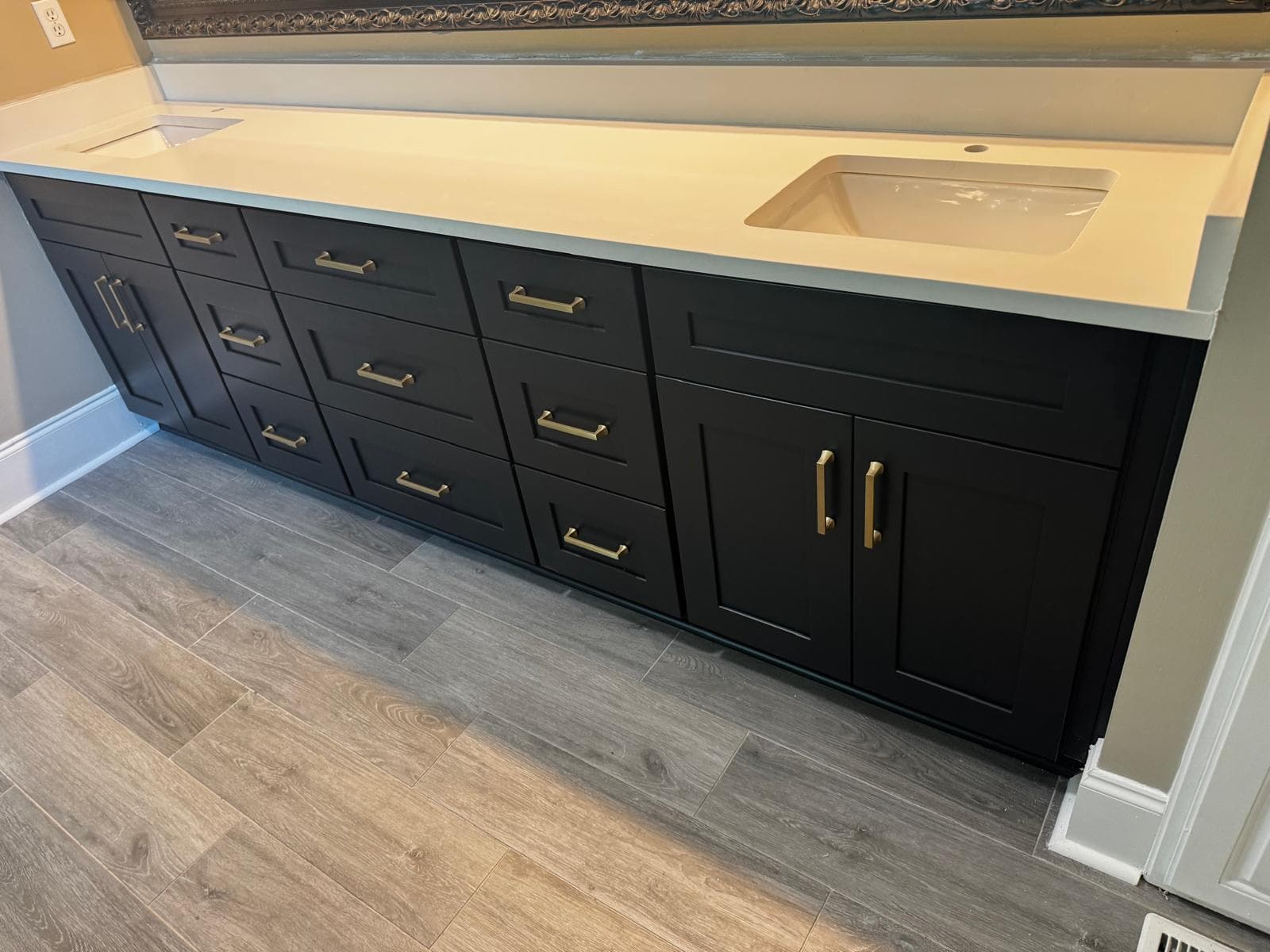 Navy blue bathroom vanity with white quartz counter under sconce lighting, Atlanta, GA