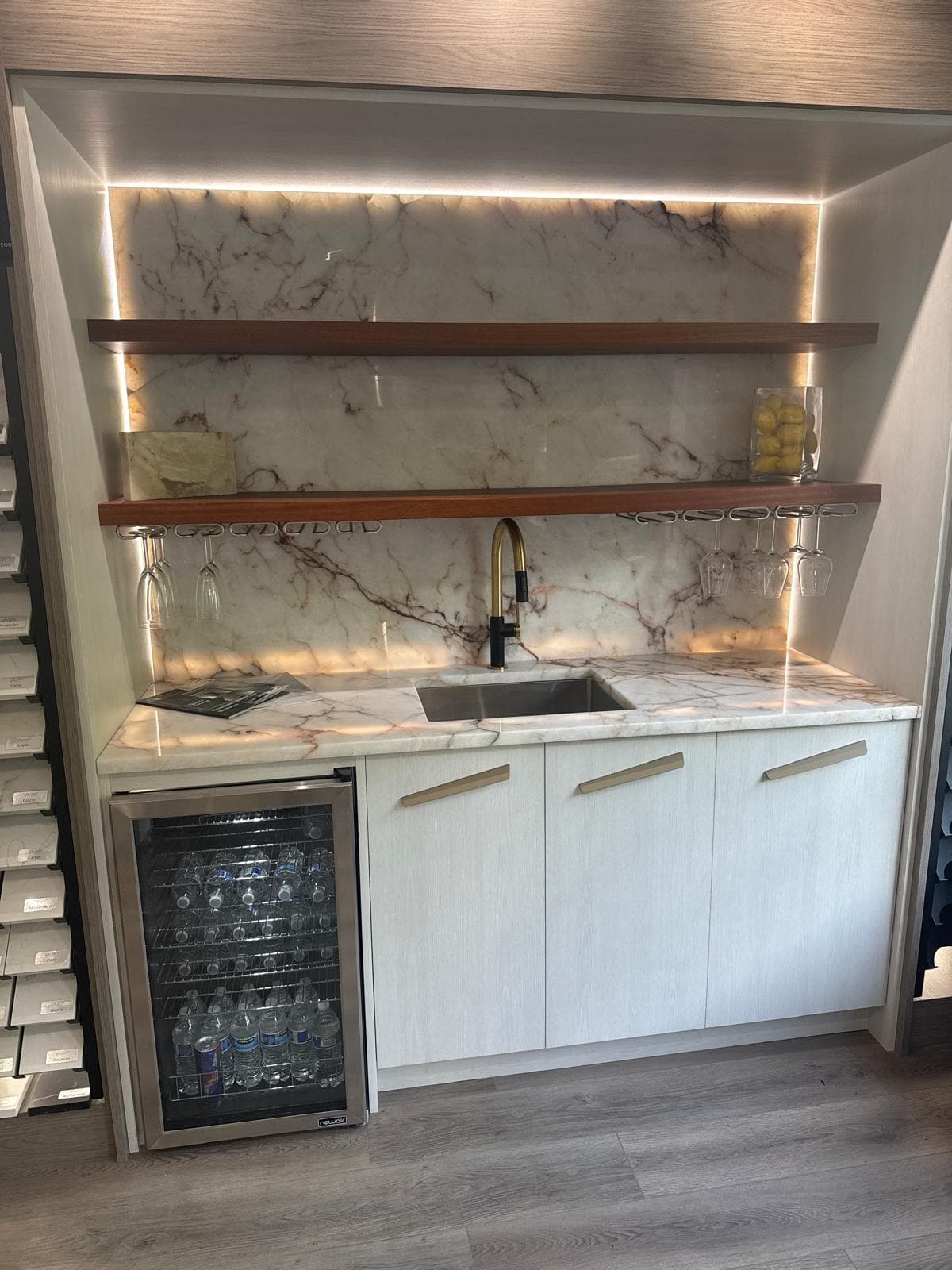 Custom wet bar cabinetry with marble backsplash, gold fixtures and wine storage, Atlanta, GA