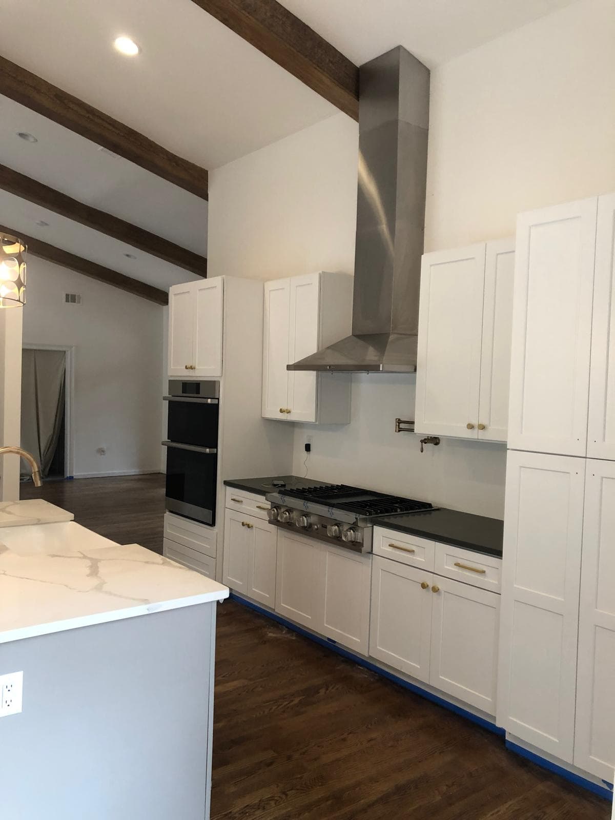 Gas cooktop with stainless steel range hood and quartz backsplash, Atlanta, GA