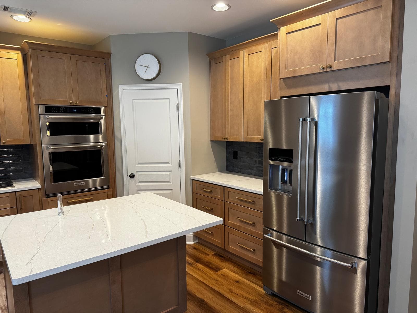 Full view of honey oak kitchen cabinets with quartz countertops, Atlanta, GA
