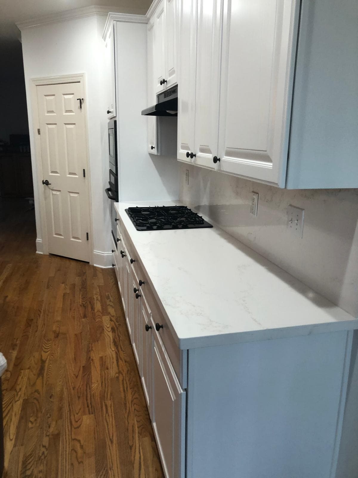 Quartz kitchen island open to staircase and living area, black appliances, Atlanta, GA