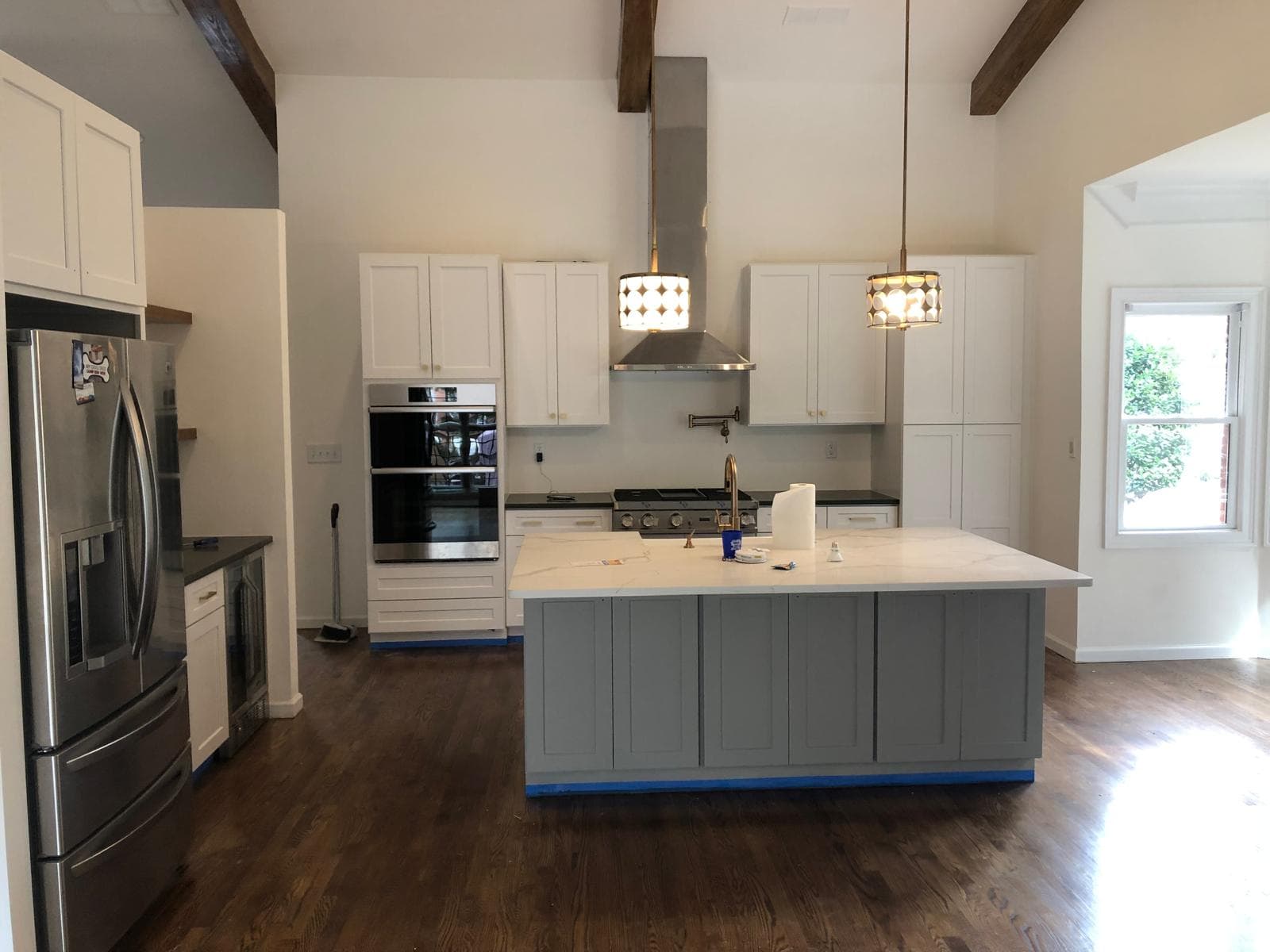 Kitchen remodel with wood beam vaulted ceiling and quartz island installation, Atlanta, GA