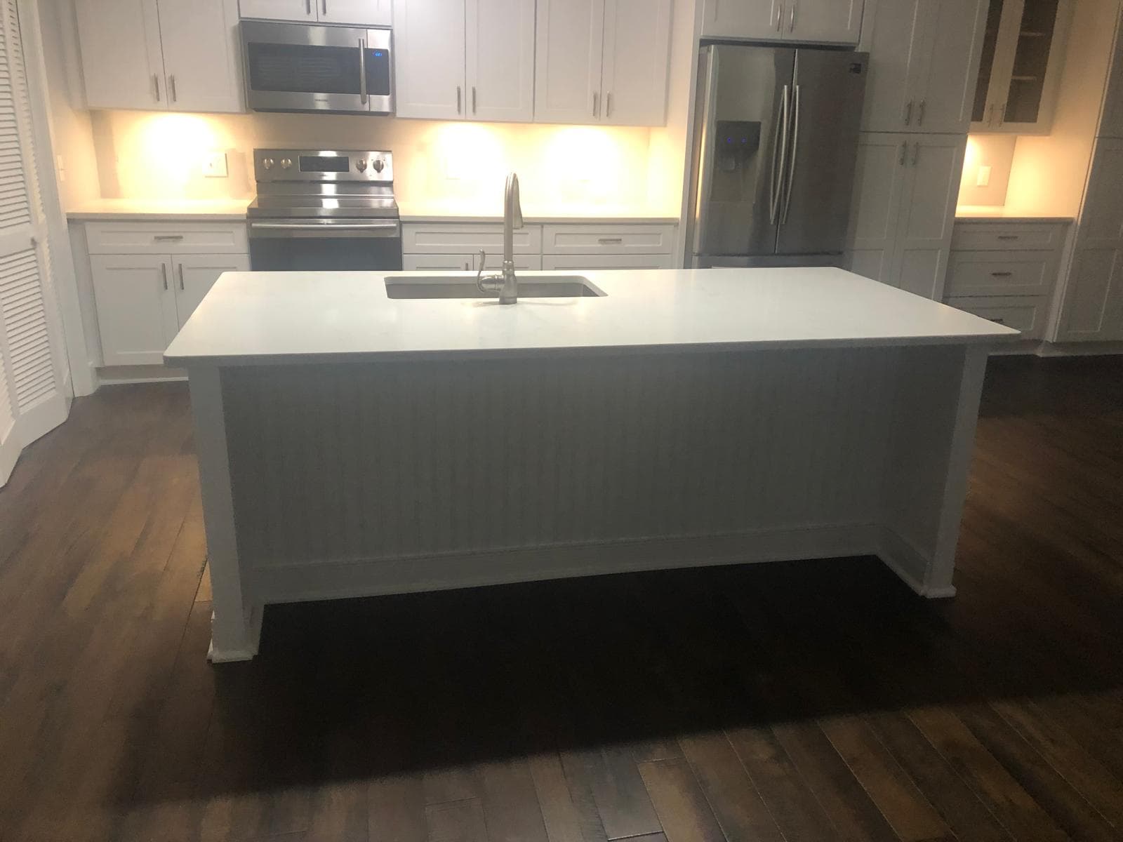 White shaker kitchen cabinets with quartz-top island, Atlanta, GA